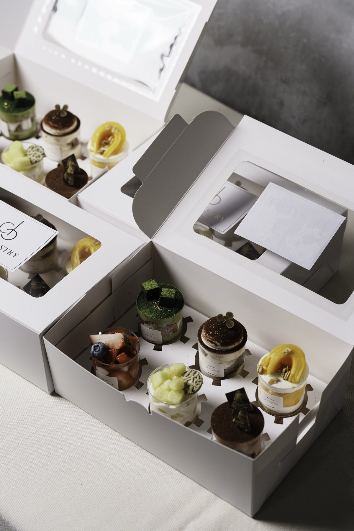DECI PASTRY parfait cups boxed for delivery — matcha, tiramisu, mango, strawberry and melon